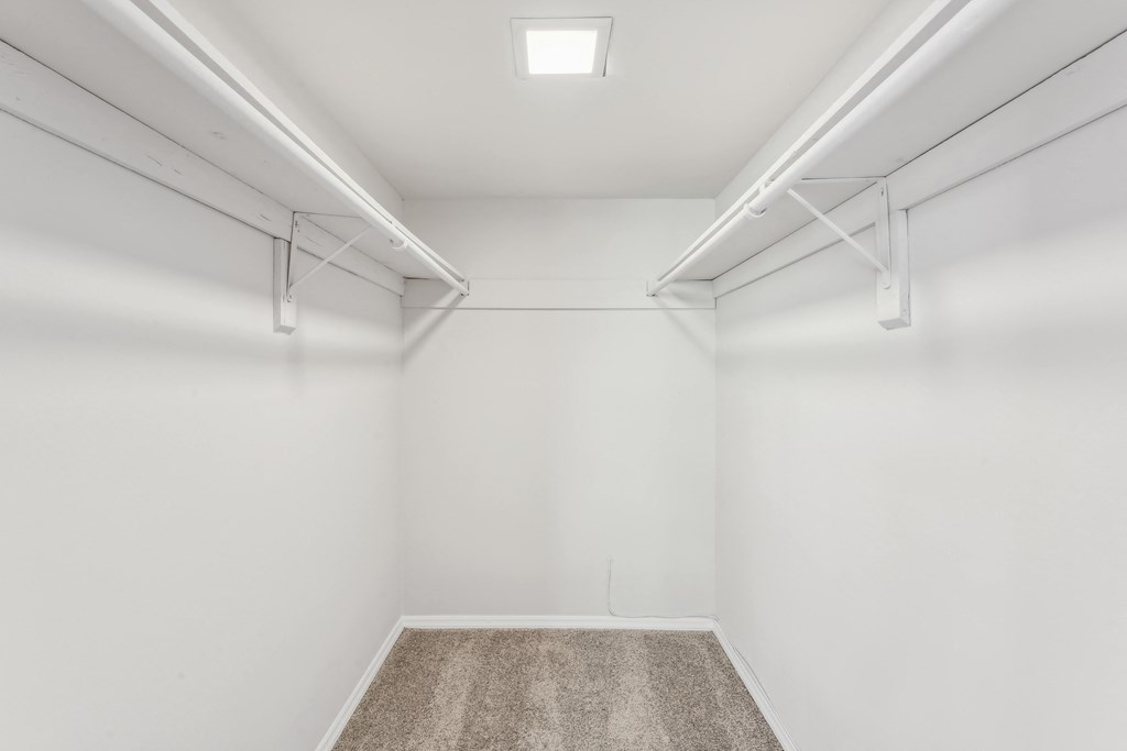 an empty room with white walls and a carpet