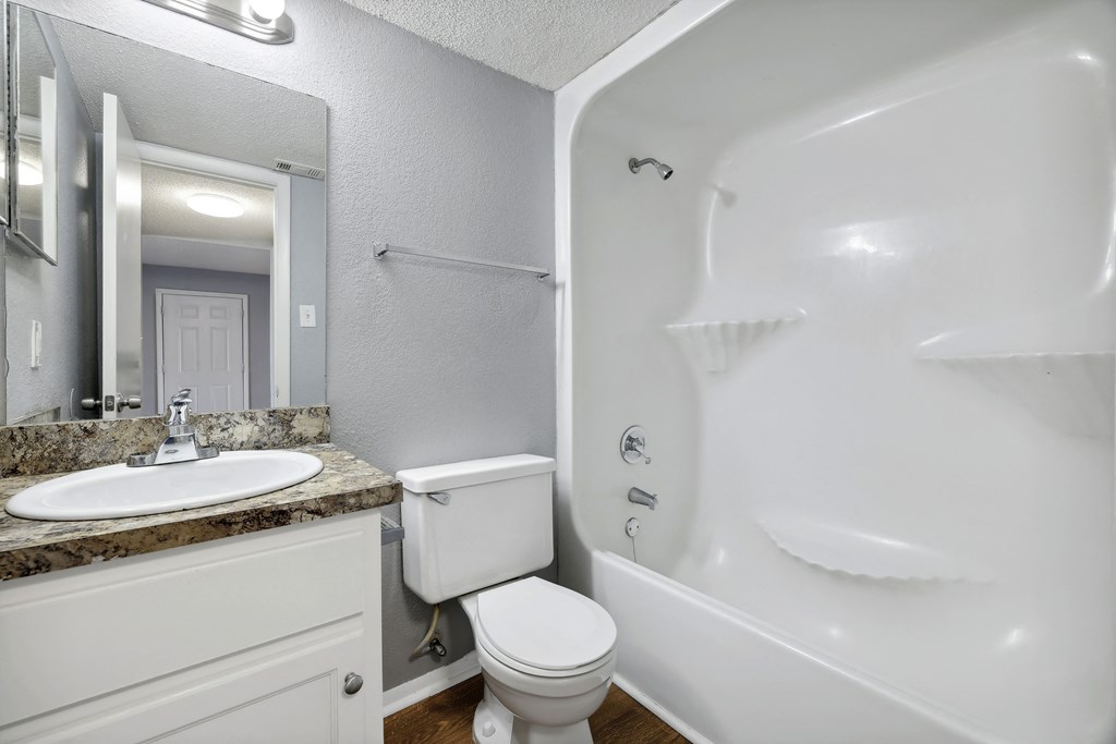 a bathroom with a sink toilet and a bath tub  at Governors House, Huntsville, AL