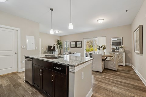 A kitchen with a black counter top and brown cabinets.