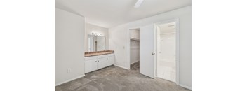 A room with a vanity and a mirror.
