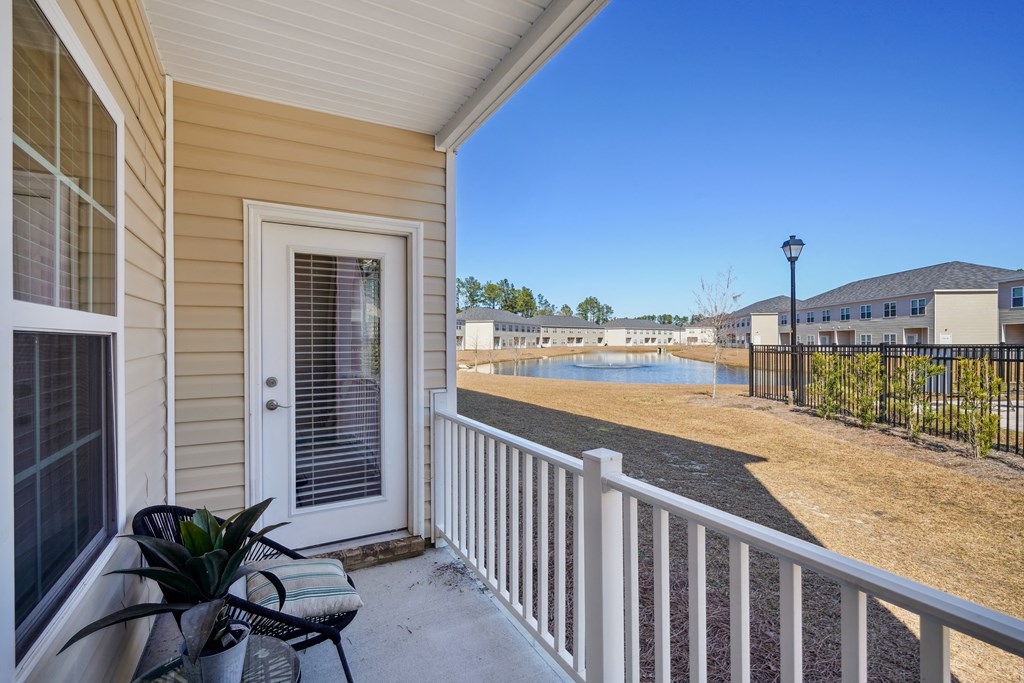 Front porch view of a house with a lake at The Meadows, Georgia, 31302