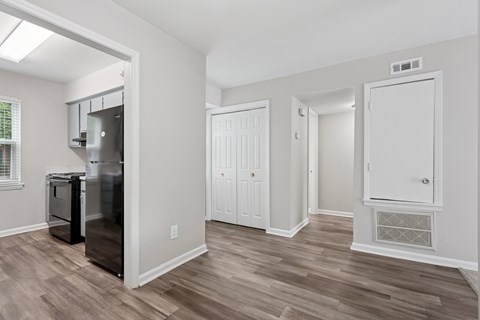 A kitchen area with a fridge, a dishwasher and a stove.