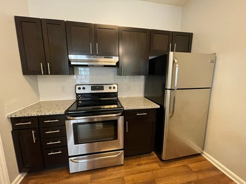 a kitchen with stainless steel appliances and black cabinets