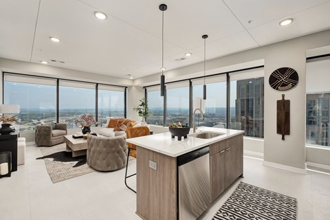 Kitchen island with white countertop and pendant lights at The 600 Apartments, Birmingham, Alabama