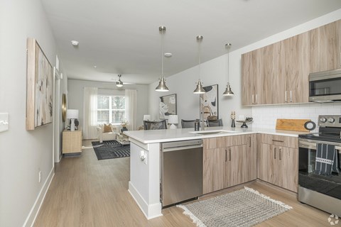 A modern kitchen with wooden cabinets and stainless steel appliances.