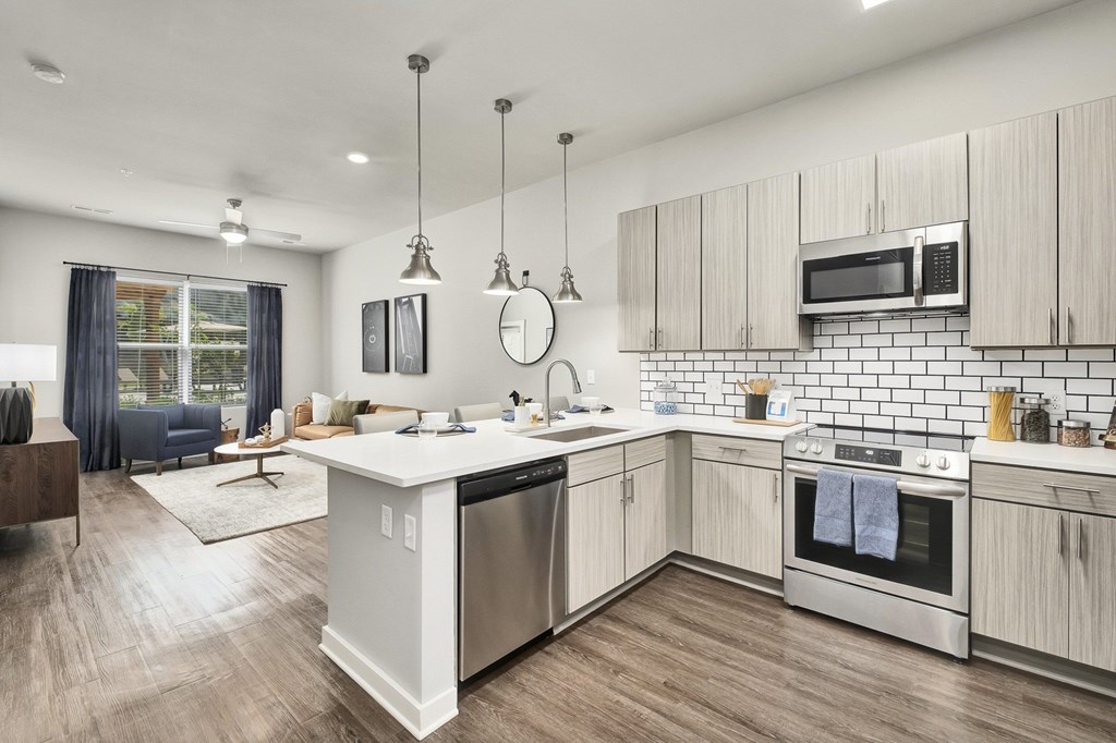 A modern kitchen with a large island and stainless steel appliances at The Percy Apartments, Nashville, TN, 37214