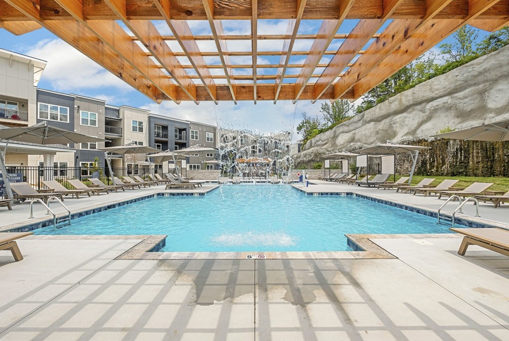 A large swimming pool with a wooden roof and tiled floor at The Percy Apartments, Nashville, 37214