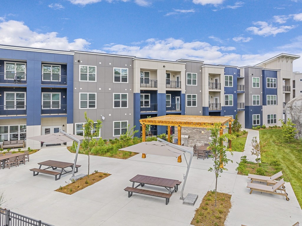 A large apartment complex with a courtyard and picnic tables at The Percy Apartments, Nashville, TN