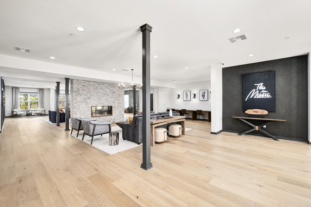 A modern living room with a fireplace and a dining table at The Percy Apartments, Nashville