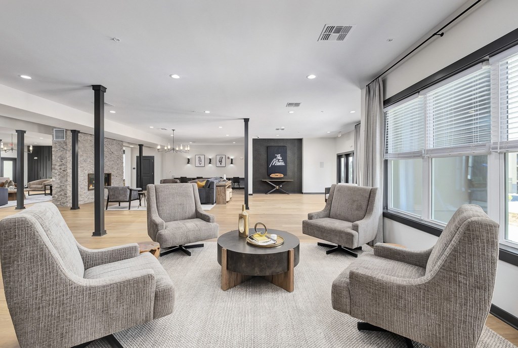 A living room with grey chairs and a coffee table at The Percy Apartments, Tennessee