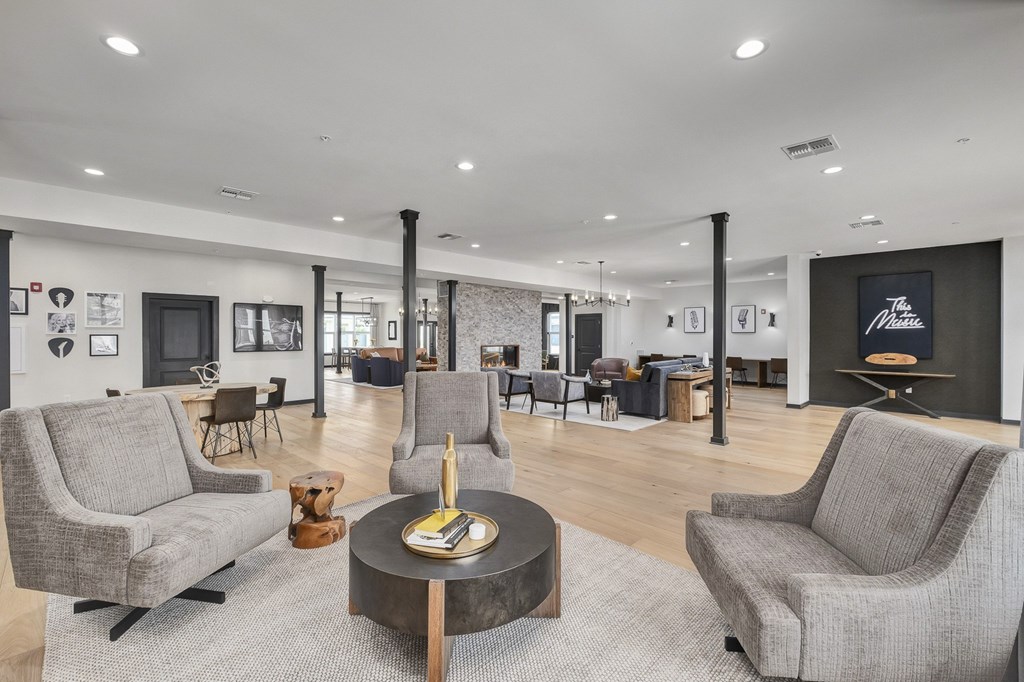 A living room with grey chairs and a coffee table at The Percy Apartments, Tennessee, 37214