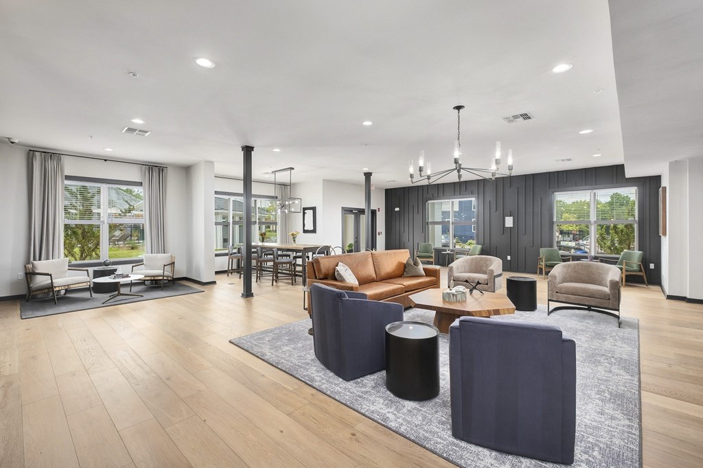 A modern living room with a large sectional sofa and a coffee table at The Percy Apartments, Nashville, TN