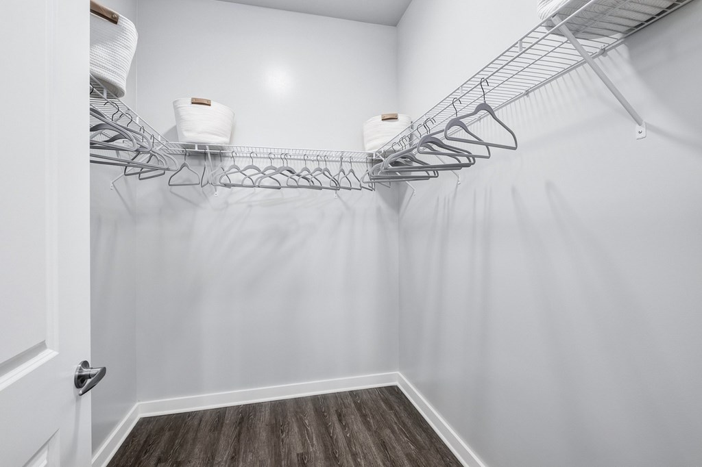 A white closet with a wooden floor and a white door at The Percy Apartments, Tennessee, 37214