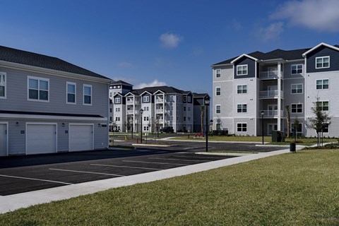 Apartment complex with a parking lot in front at The Waverly at Winter Haven Apartments, Florida