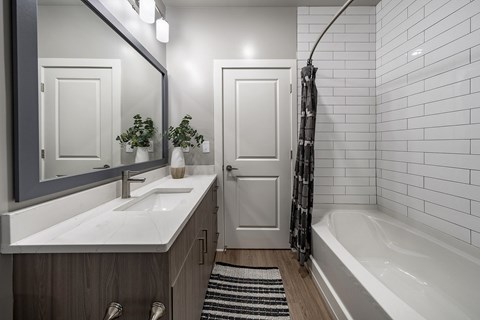 A white sink with a mirror above it at The Waverly at Winter Haven Apartments, Florida
