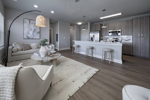 A modern living room with a white sofa and a grey armchair at The Waverly at Winter Haven Apartments, Winter Haven, 33884