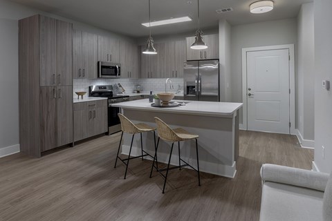 A modern kitchen with a dining table and chairs.