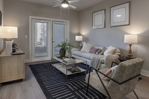 A living room with a couch, chair, and two lamps at The Waverly at Winter Haven Apartments, Winter Haven, FL