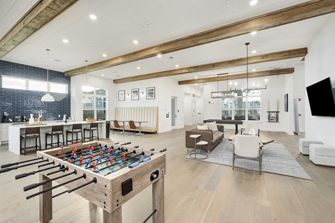 A foosball table is in the middle of a living room.