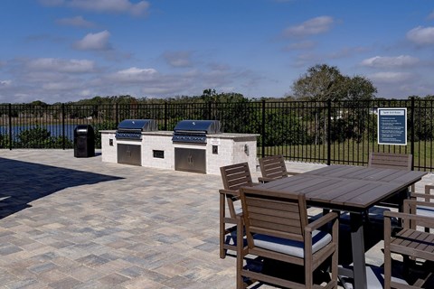 A patio with a table and chairs and a fence at The Waverly at Winter Haven Apartments, Winter Haven, FL