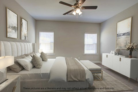 A bedroom with a large bed and a ceiling fan.