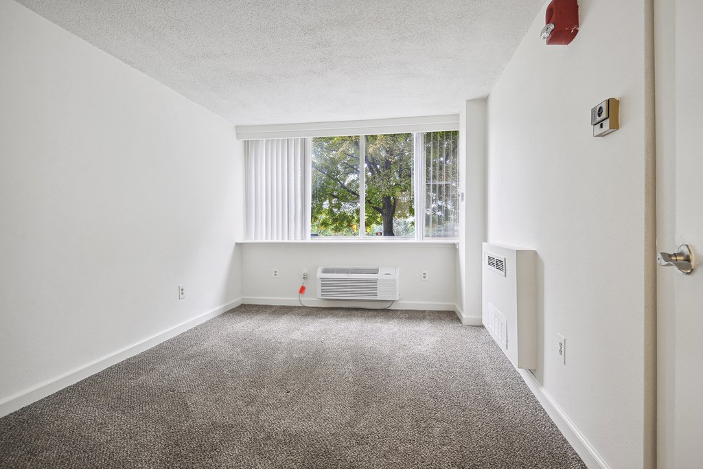 Bright bedroom with plush carpet at Broadstone Van Dorn