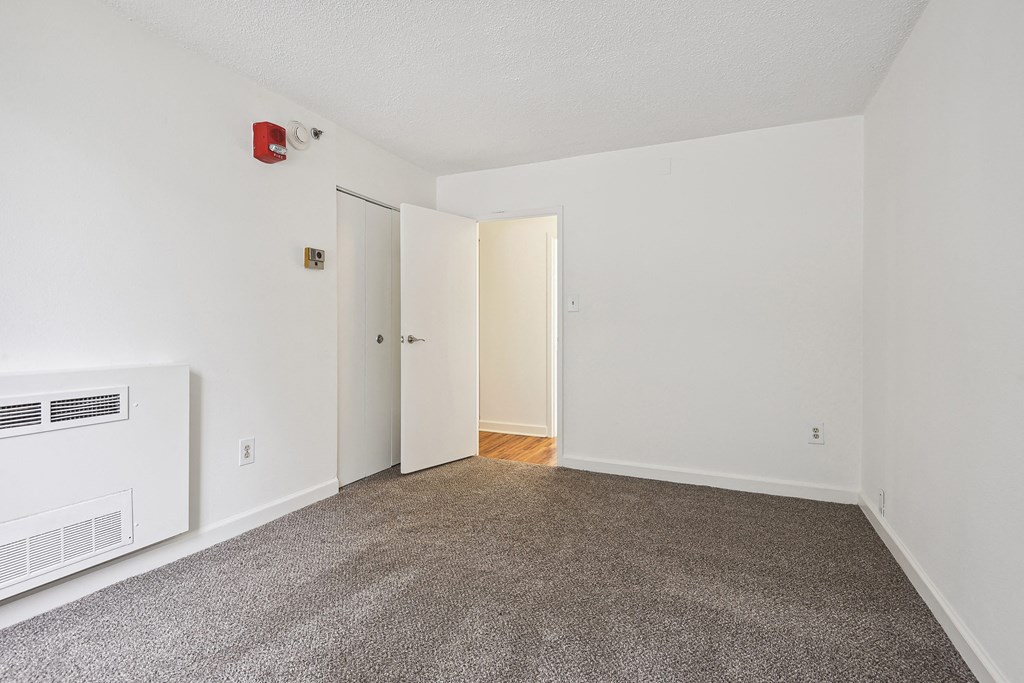 Bright bedroom with plush carpet at Broadstone Van Dorn
