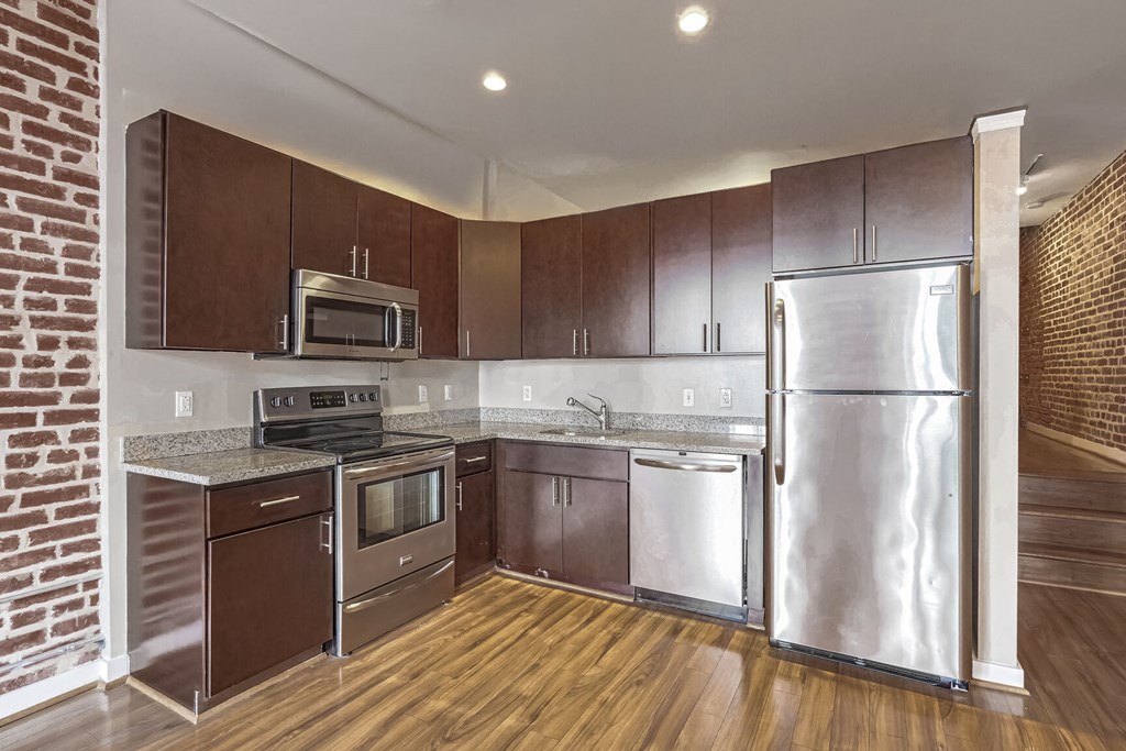 a kitchen with stainless steel appliances and wooden cabinets