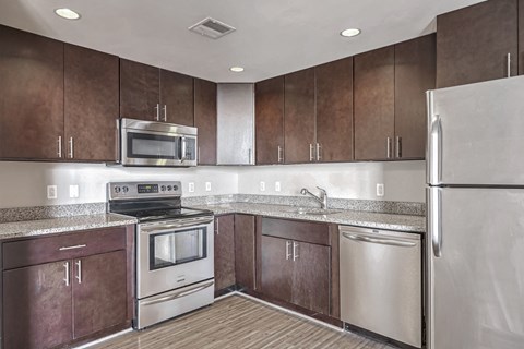 a kitchen with stainless steel appliances and wooden cabinets