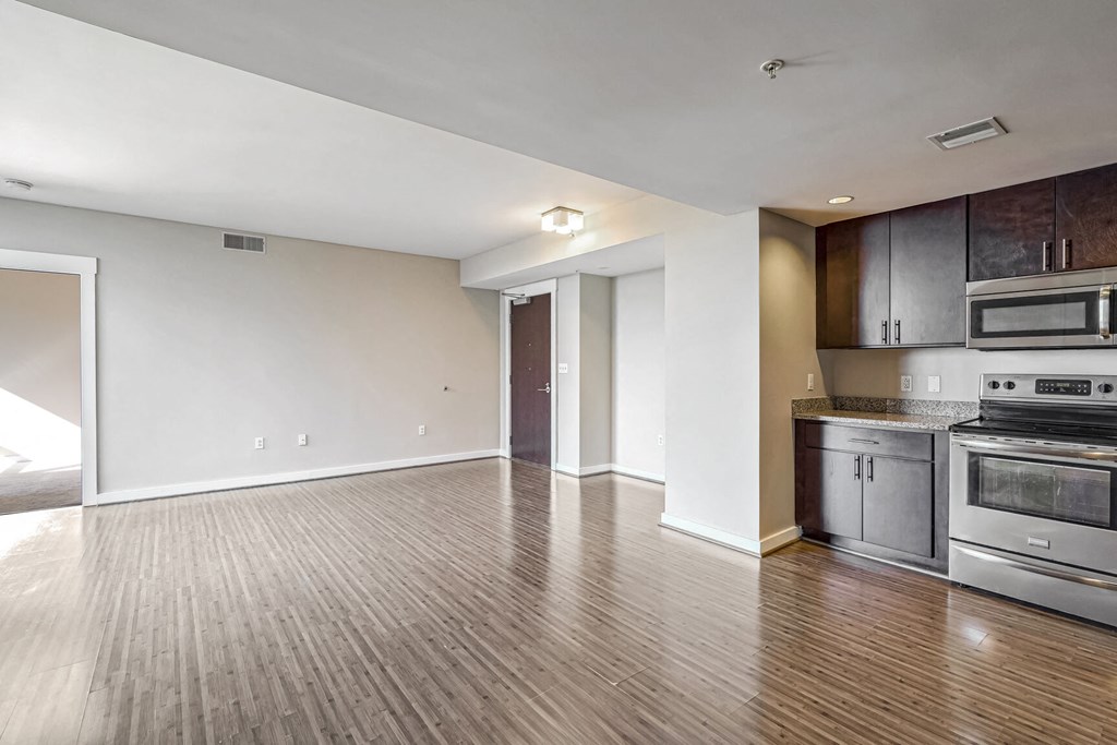 a kitchen with stainless steel appliances and a wooden floor
