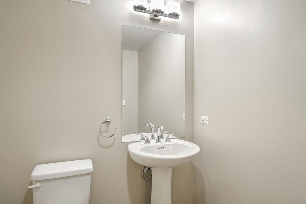 a bathroom with a sink and a mirror and a toilet