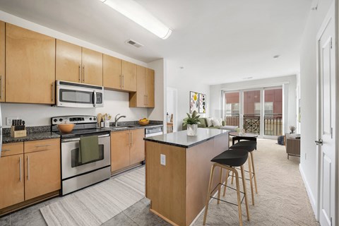A kitchen with wooden cabinets and a black countertop.