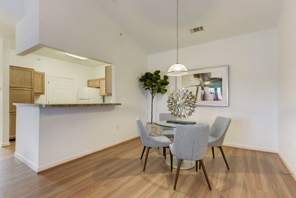 a dining room with a table and chairs and a kitchen
