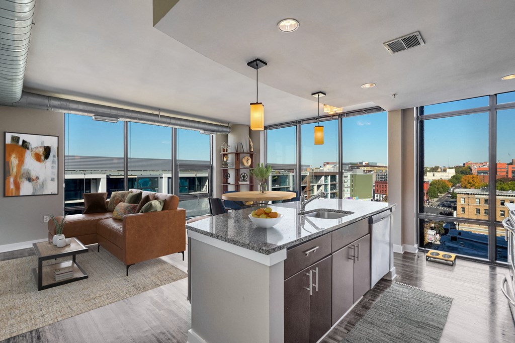 an open kitchen and living room with a view of the city