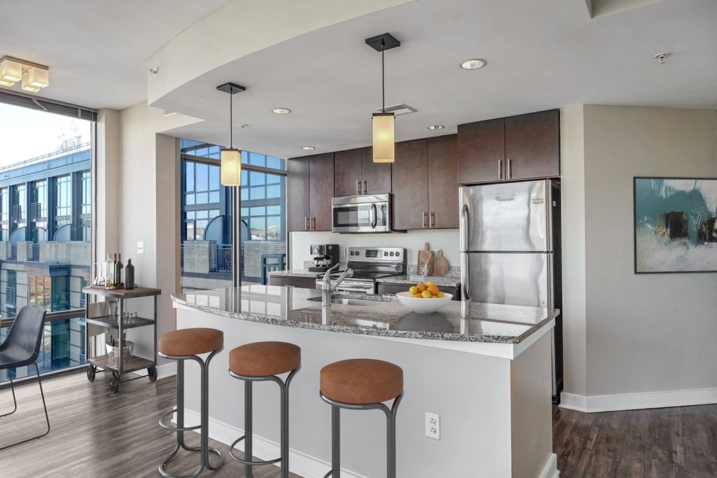 a kitchen with a large island with four stools