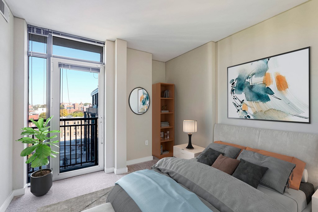 a bedroom with a bed and a sliding glass door to a balcony