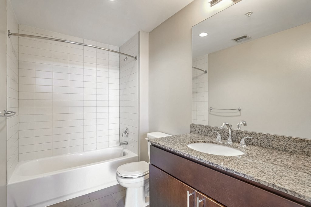 a bathroom with a sink and a toilet and a bath tub