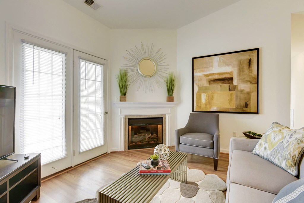 a living room with a couch and a chair and a fireplace