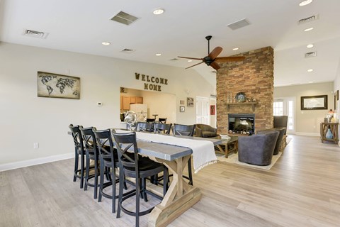 a dining room with a table and chairs in front of a fireplace
