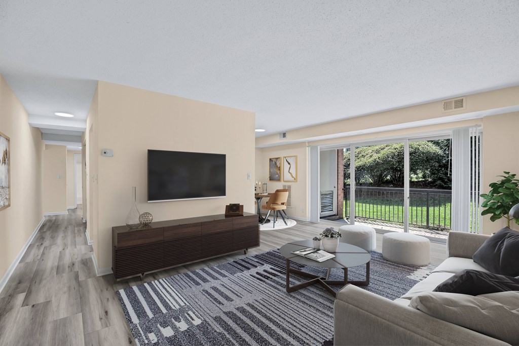 A living room with a television, a couch, and a coffee table.