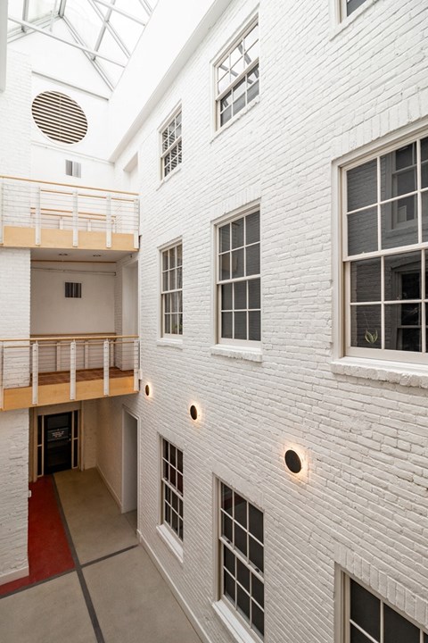 a view of a white building with windows and a staircase