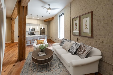 A living room with a white couch and a coffee table.
