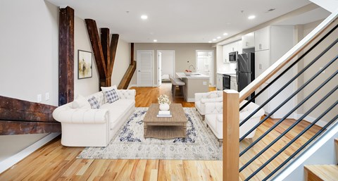 A living room with a white couch and a coffee table.