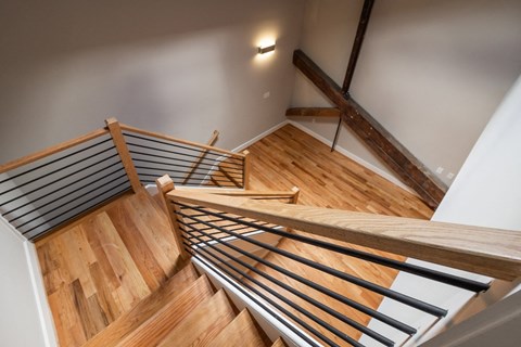 a view of a staircase with wood and metal railings