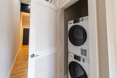 a laundry room with a washer and a dryer in a door