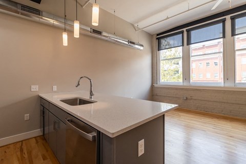 an empty kitchen with a sink and a window