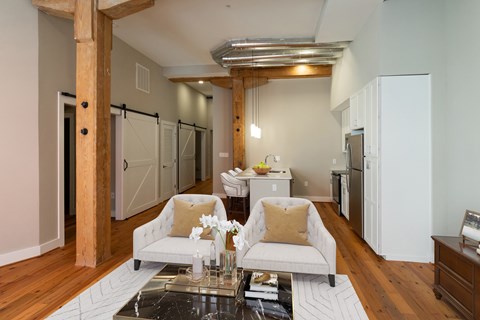 A living room with a white couch and a coffee table.