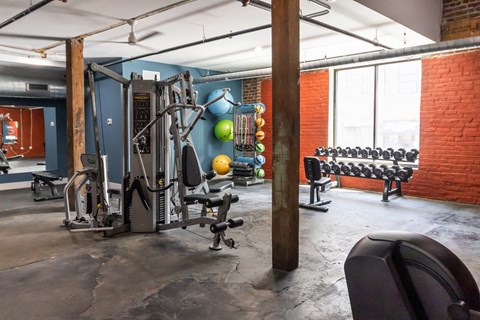 a gym with weights and other equipment in a loft space