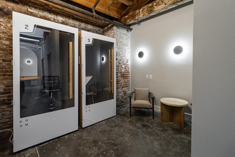 a room with two doors and a chair and a table