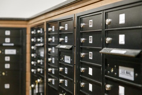 a row of mailboxes on a wall with labels on them